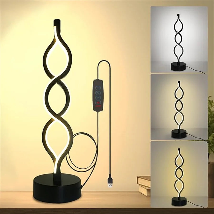 A black desk lamp shaped like a spiraling seaweed illuminates a workspace.