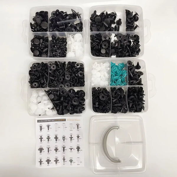 A collection of black and white plastic retainer clips for auto trim and bumper components.