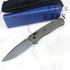 A folding EDC pocket knife with a gray handle and blade is shown next to its blue sheath.