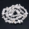 A collection of white and gray natural agate beads arranged in a circular pattern.