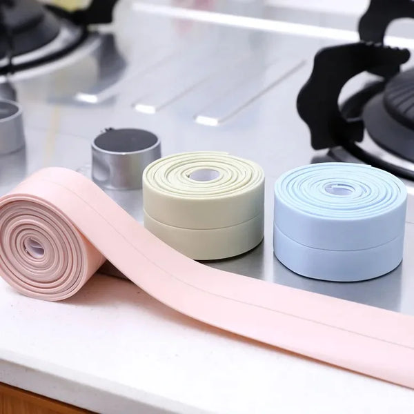 Rolls of pink, beige, and light blue PVC sealing strips for bathroom and kitchen use