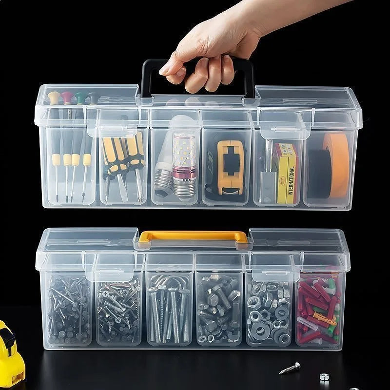 A hand is holding a clear multi-compartment tool organizer box set with various tools inside.