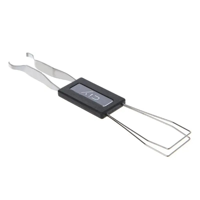 A silver key extractor tool with a black handle and wire loops for removing mechanical keyboard switches.