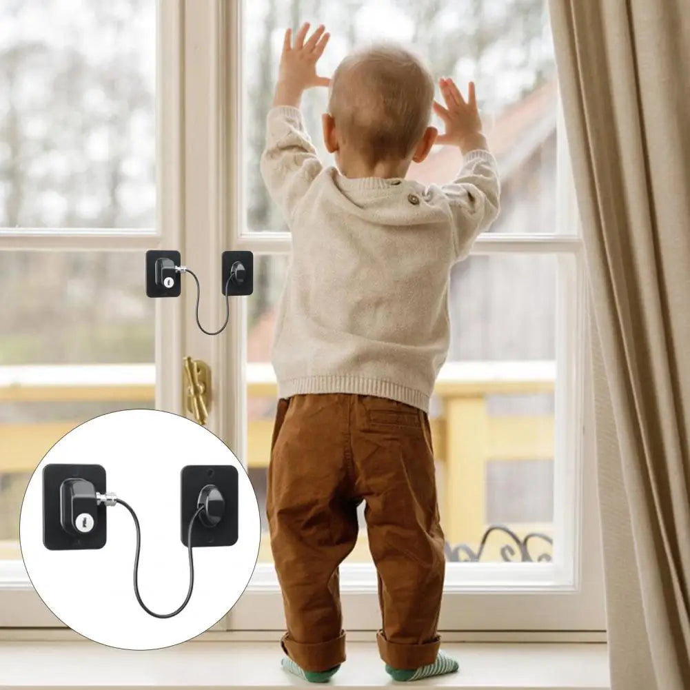 A baby is playing near a window with universal door and window safety locks installed on the frame.