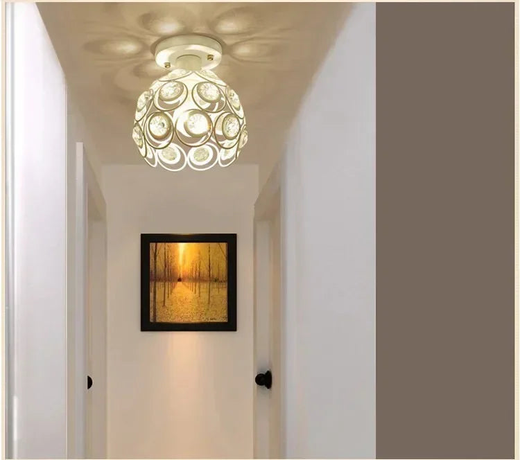 Crystal LED chandelier lamp hanging in a hallway with a framed light display.