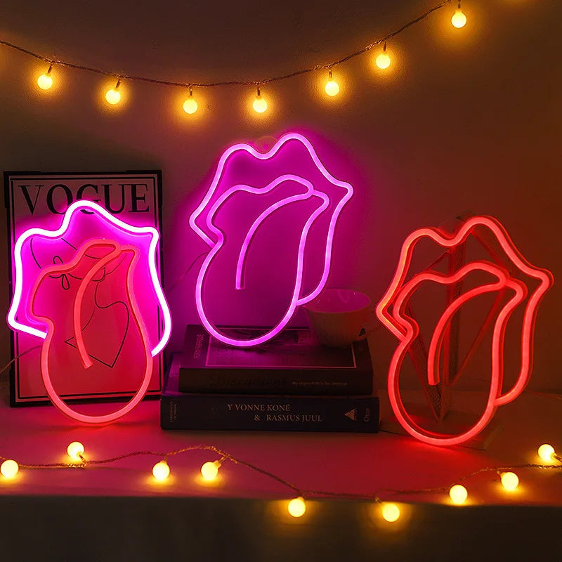 Neon pink heart lip light decoration glowing on a dark background with string lights.