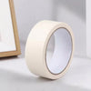 A roll of white painter's tape used for masking trim and grout.