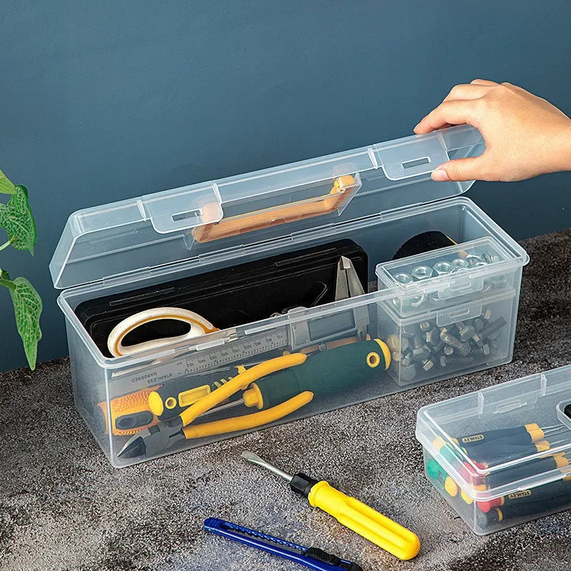 A clear multi-compartment tool organizer box set containing various hand tools and accessories.