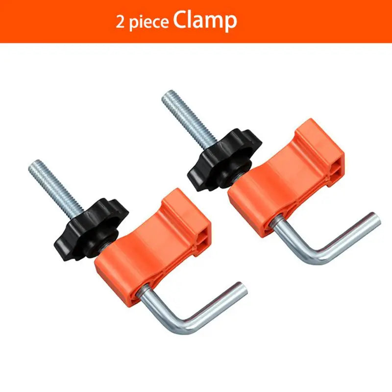 Two orange and black clamp pieces used as a 90-degree angle positioner for woodworking