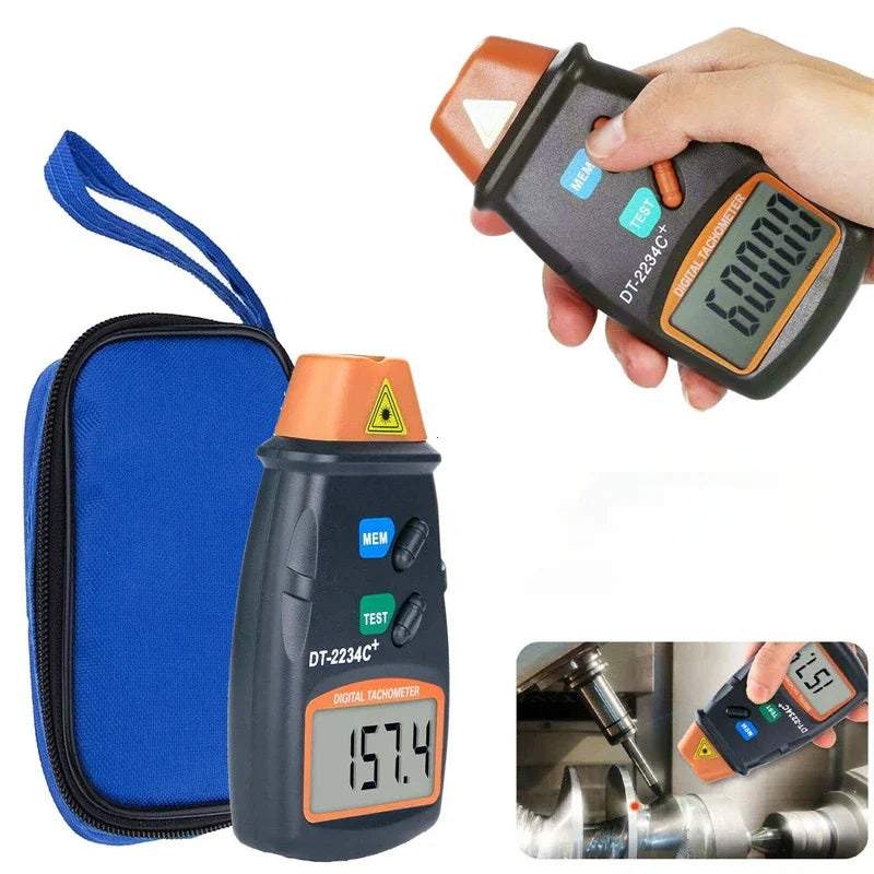 A hand holds a digital non-contact laser tachometer measuring speed on a metal surface.