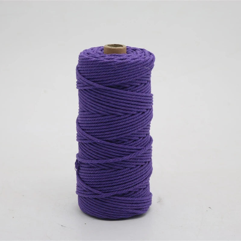 A spool of 100m natural cotton macrame cord in purple.