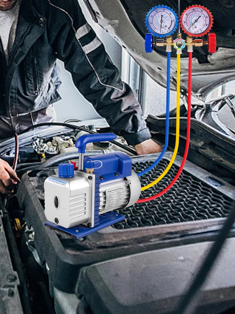 A blue refrigeration vacuum pump kit with gauges and tubing is installed in a car engine bay.