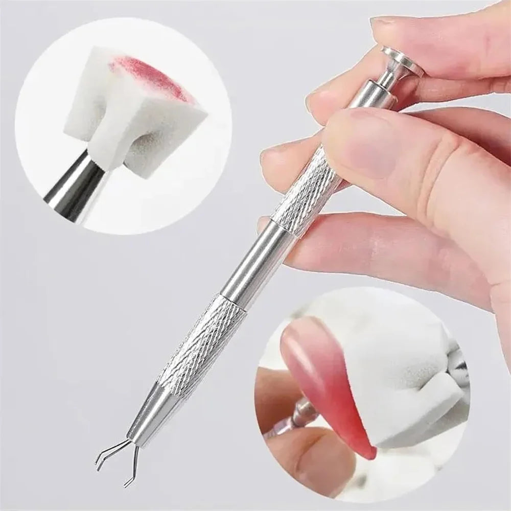 A hand is holding a silver nail art sponge set with a gripping pen, showing the sponge and tip.