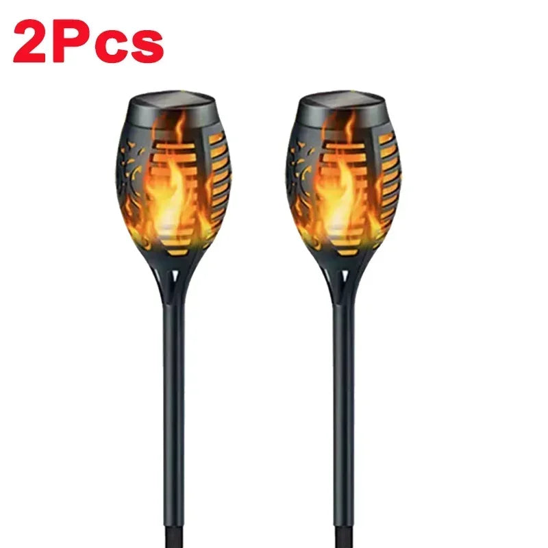 A pair of black solar flame torch lights for outdoor decoration.