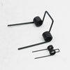 A set of black precision double torsion springs used for DIY projects.