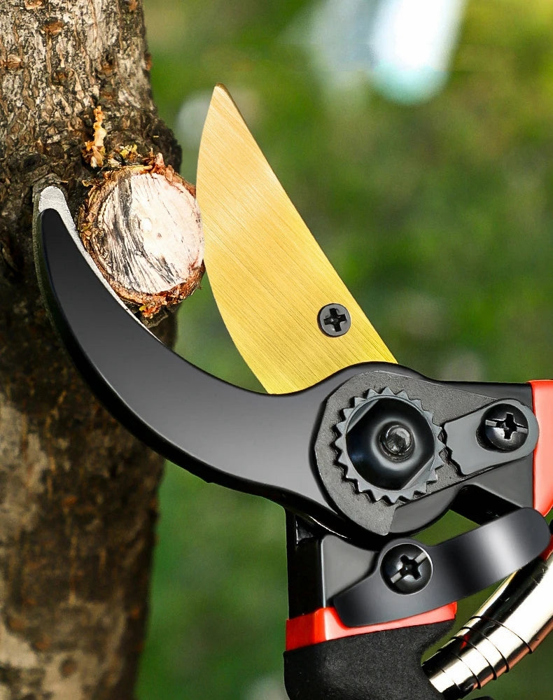 A close-up of professional metal pruning shears with a yellow blade and black handle, positioned near a tree trunk.