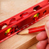 A red magnetic level ruler is shown next to a pencil on a wooden surface.