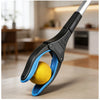 A close-up of a black and blue foldable litter picker tool gripping a yellow ball.