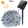 A cluster of white LED string lights powered by a solar panel, shown next to a sun icon.