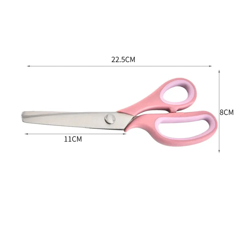 Pair of pink and silver stainless steel zigzag tailor scissors with dimensions 22.5cm long.