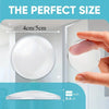 A clear silicone door handle bumper is shown next to a hand, illustrating its size and use for wall protection.