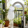 A reusable cotton faucet filter is shown actively purifying water from a modern kitchen faucet.