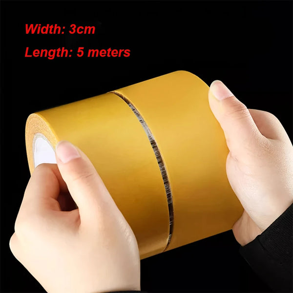 A hand is holding a roll of yellow heavy duty fabric repair tape, showing its width and length.