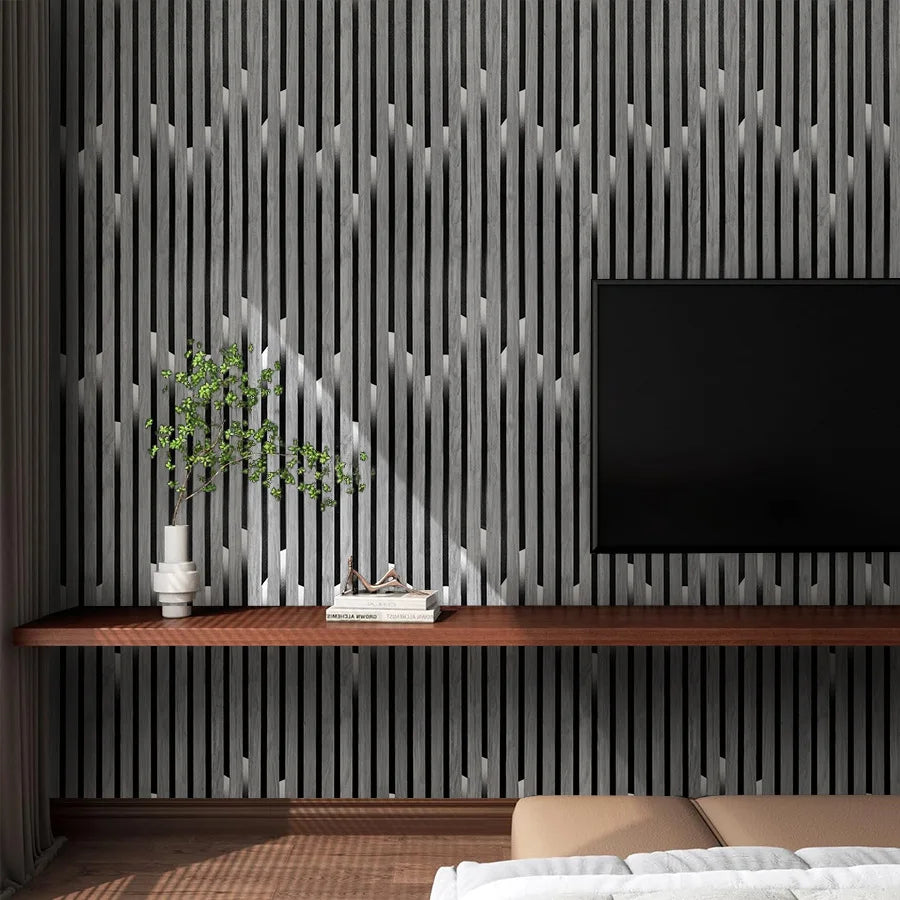 A modern interior featuring a dark wood shelf and a large black television against a vertical gray wood slat wall.