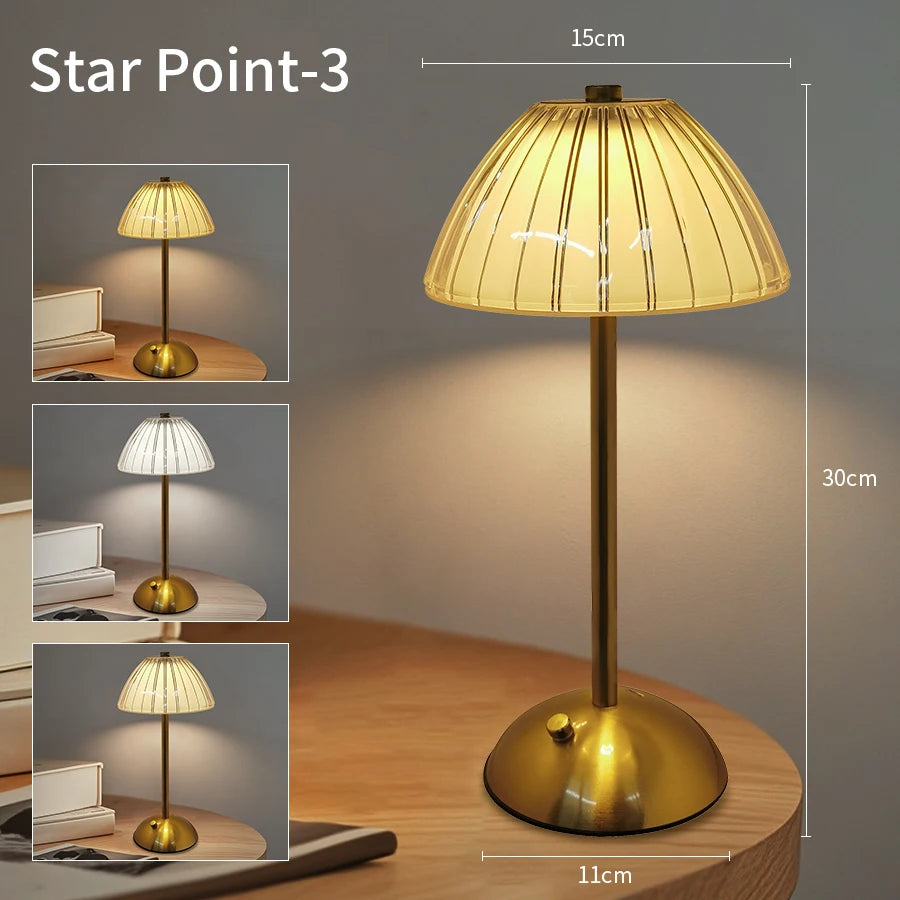 A golden touch sensor desktop reading lamp with a conical shade and brass base.