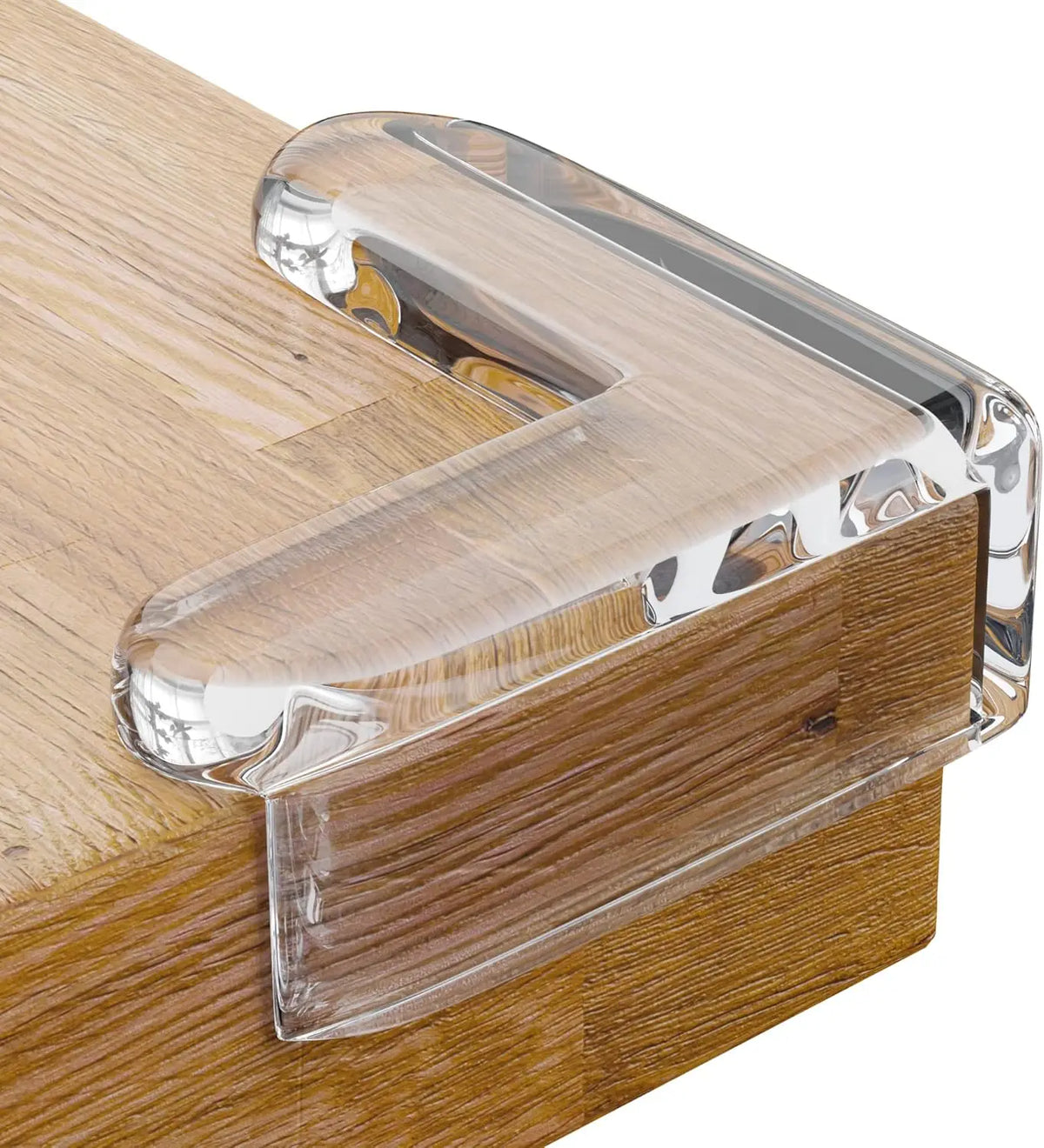 Clear silicone corner edge protector installed on a wooden surface for baby safety.