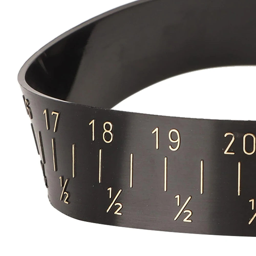 Close-up of a black adjustable bangle sizer and measuring tool with numbered markings.