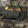 A black and camouflage toolkit bag with yellow trim resting on a dark rock surface.
