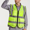 A man wearing a lime green high-visibility reflective safety vest over a gray shirt.