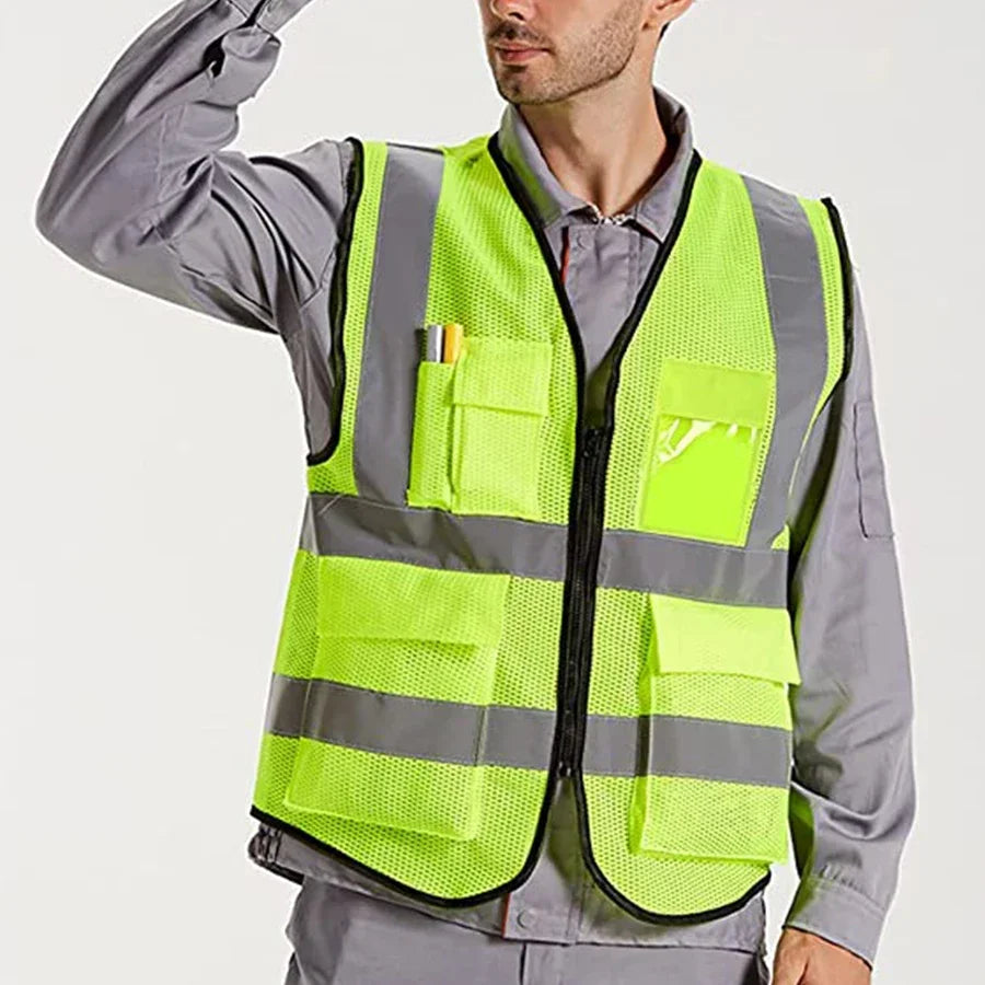 A man wearing a lime green high-visibility reflective safety vest over a gray shirt.
