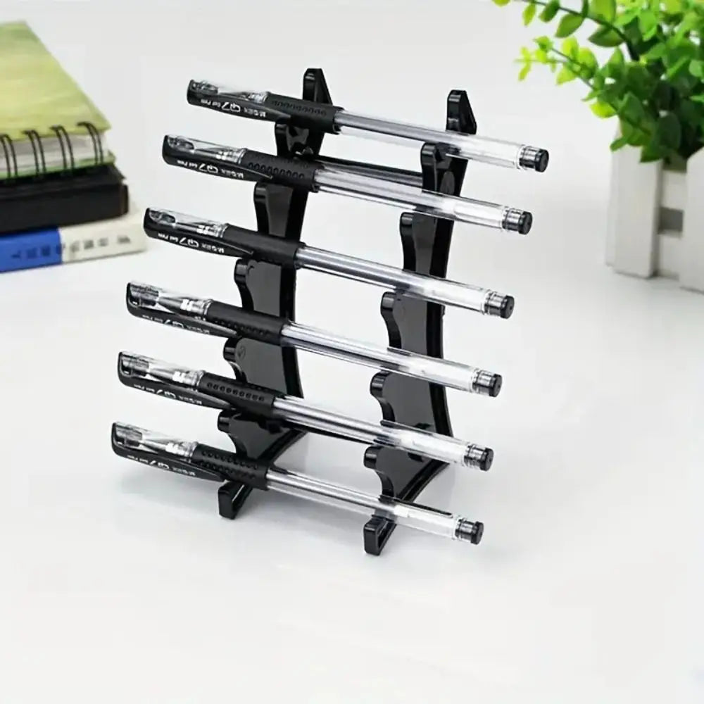 A black pen holder organizer with multiple transparent ballpoint pens arranged vertically.