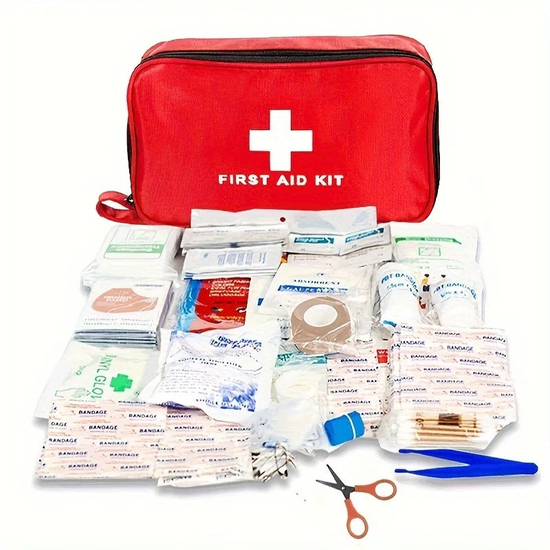 A red first aid kit bag filled with various medical supplies including bandages and scissors.