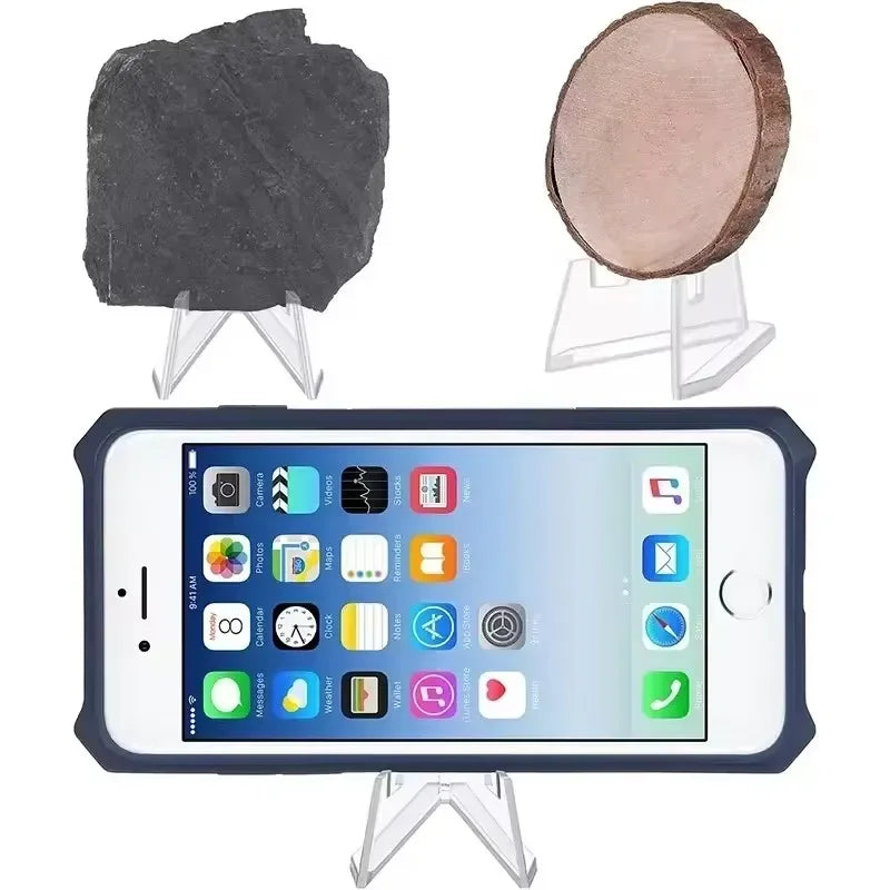 Acrylic display stand showing a dark stone and a round, light brown object.