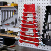 A vertical rack organizer holding multiple red plastic wrenches and sockets.