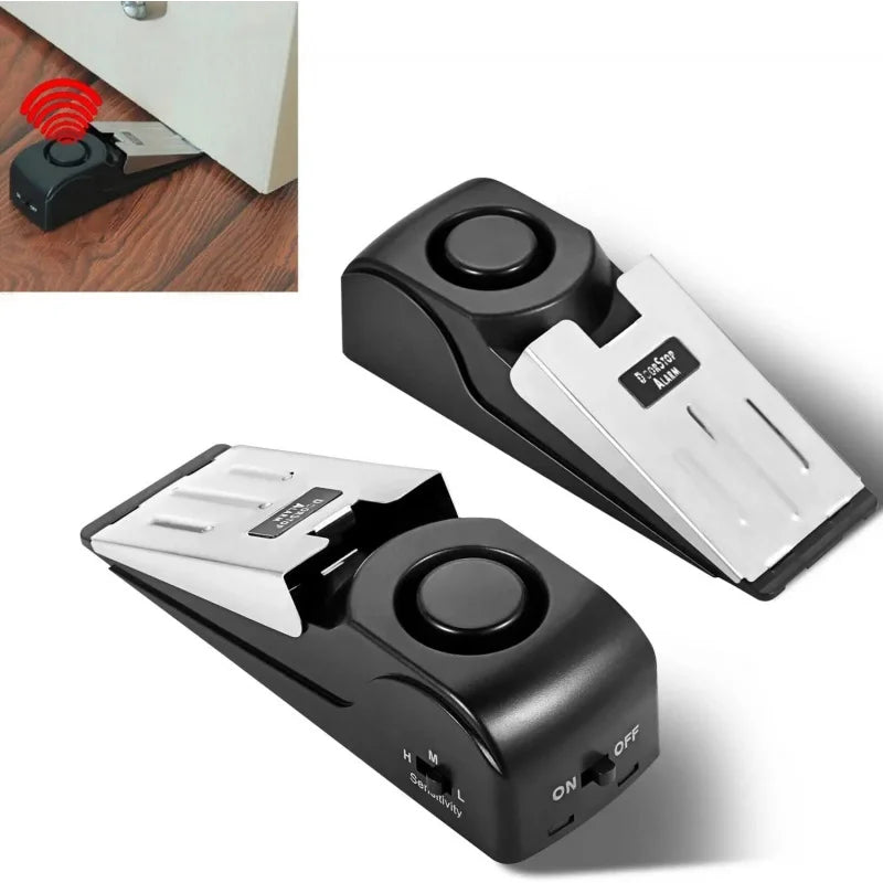A black wireless door stop alarm device shown in multiple angles.