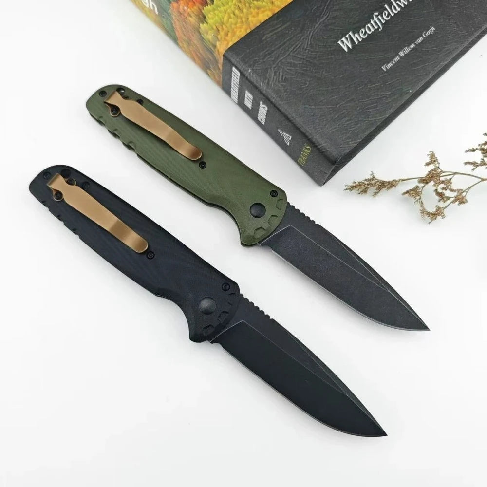 A folding utility knife with a black blade and olive green handle is shown next to a book.