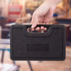 A hand is holding a black precision gunsmithing punch tool set with a textured grip.