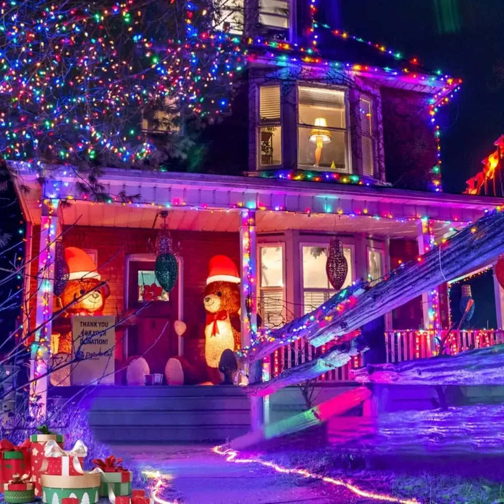 A brightly lit house decorated with colorful string lights and seasonal accents at night.
