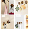 A collection of rustic wooden wall hooks and hangers used for organizing items in a shower room, kitchen, bedroom, and behind