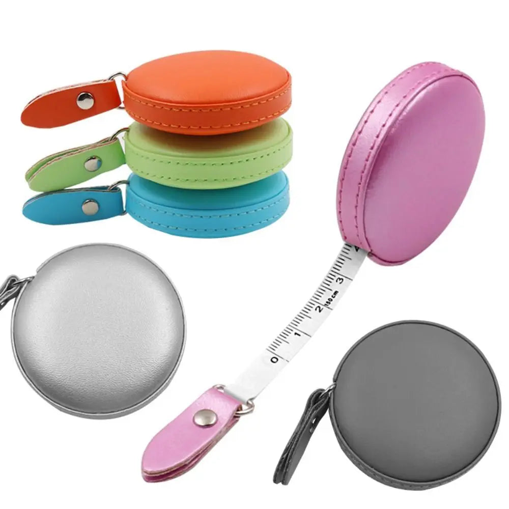 A set of retractable dual scale measuring tapes in orange, green, blue, and silver colors.