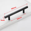 A black stainless steel T-bar cabinet handle with dimensions marked on a white surface.