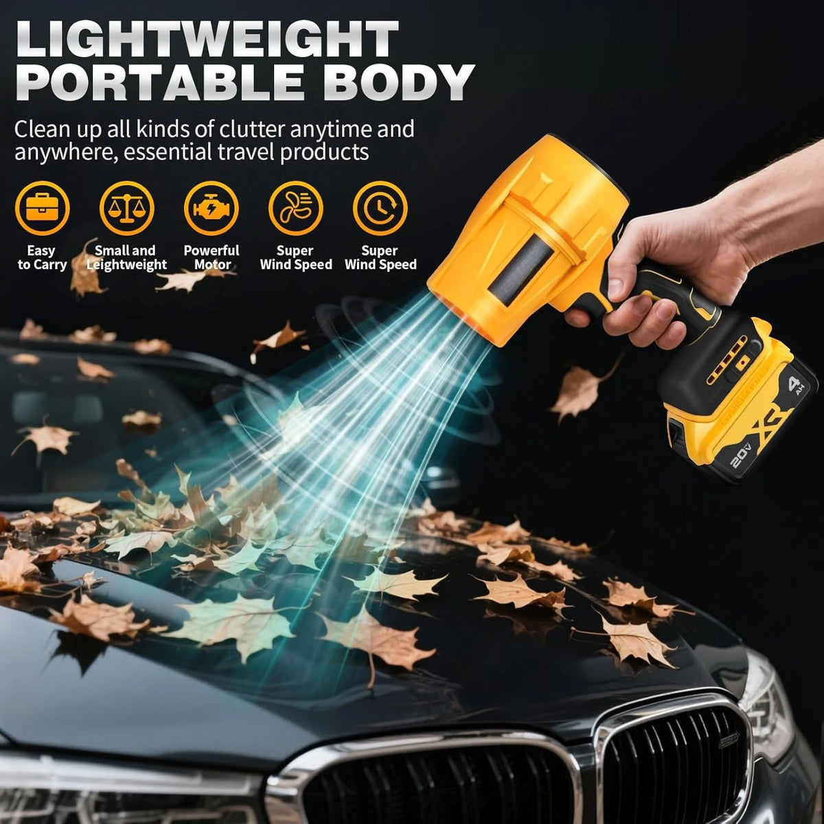 Eine Hand hält einen gelben kabellosen Laubbläser, um herabgefallenes Laub von einer Autoscheibe zu entfernen.