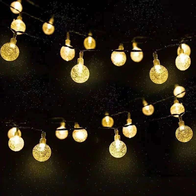 String lights with warm yellow fairy lights hanging against a dark background.