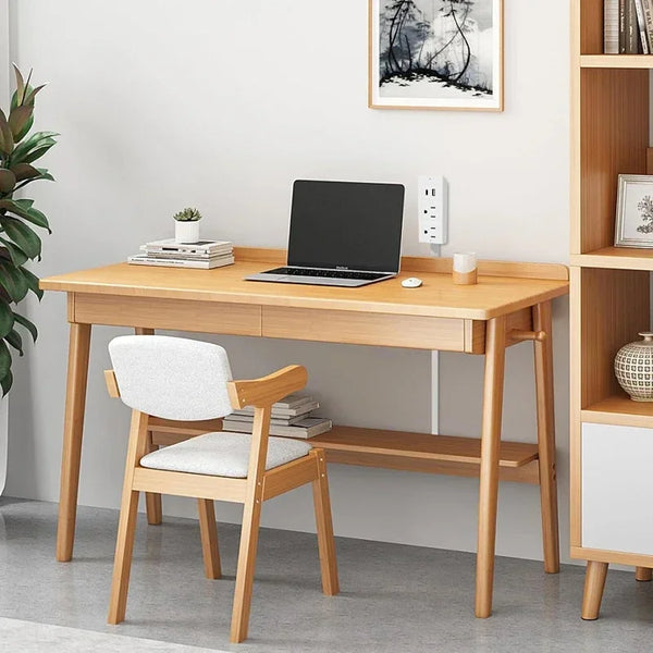 A wooden desk setup featuring a laptop, a white chair, and an electrical outlet extender on a light gray floor.