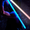 A person wielding a glowing blue lightsaber, demonstrating dynamic light and sound effects.