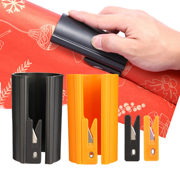 Eine Hand hält einen schwarzen und einen orangen Schneidemaschine zur Verpackung, mit sichtbaren Schneidklingen.